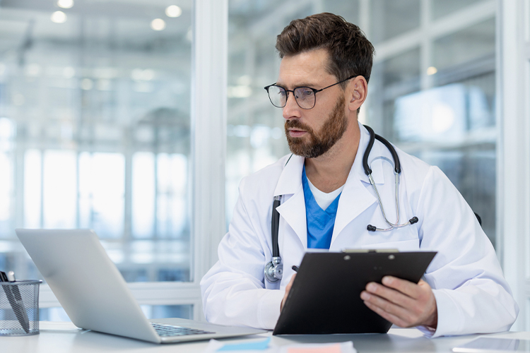 Doctor using a laptop in his office