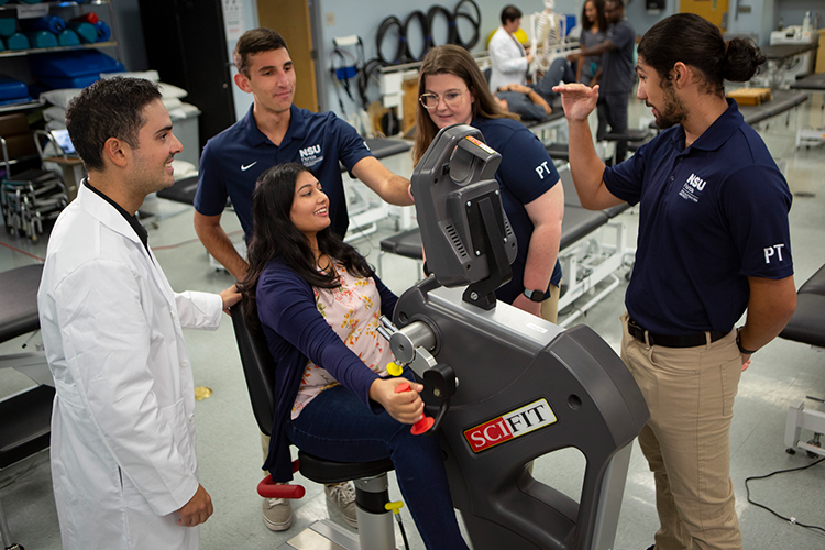 Group of physical therapists helping a woman