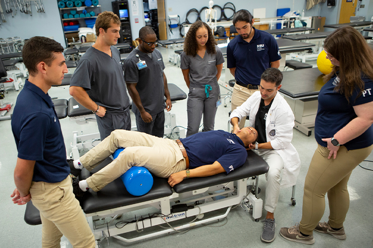 Group of physical therapists watching a demonstration