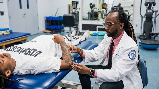 sports physical therapist working with patient on rehabilitation