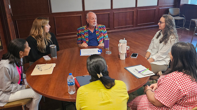 Faculty and students sitting at a round table during Residential Institute.