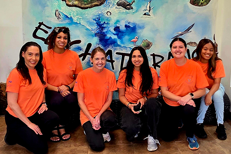 M.S. Public Health Students and Professor Posing