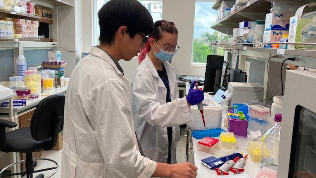 Maria Castellon and colleague working in a lab