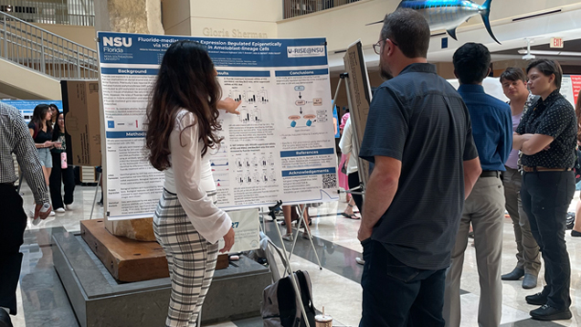 Melanie Mendonca presenting research material at an event