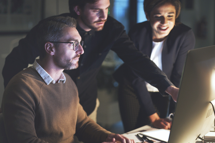 Group of front desk people solving using computer