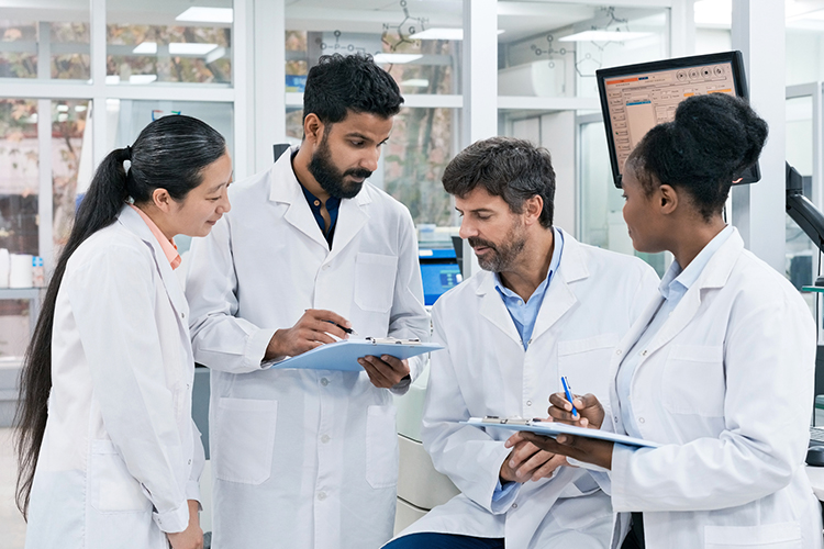 Team of scientists reviewing documents in a laboratory