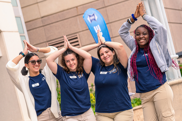 Student staff group doing fins up