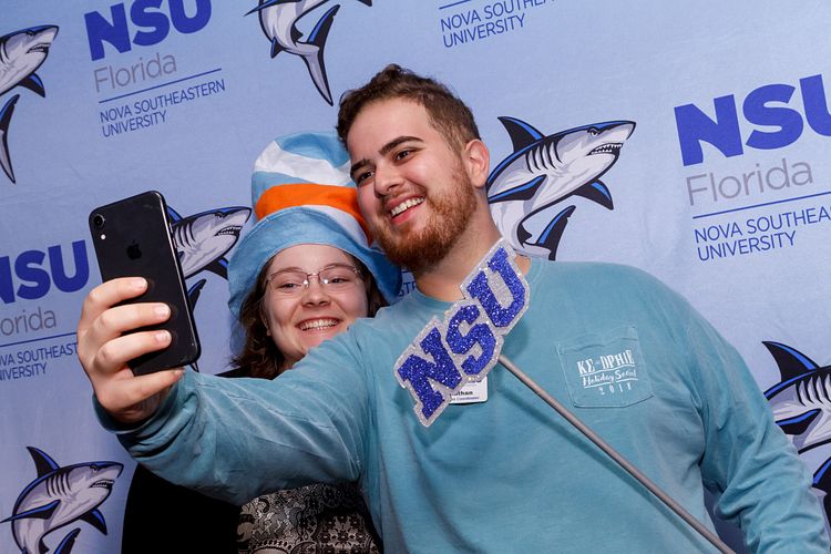 Student at event with NSU prop