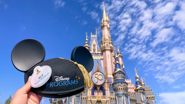 Student at disney on florida holding mickey ears hat
