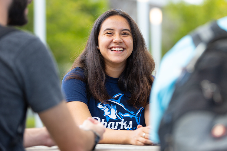 NSU student smiling outdoors