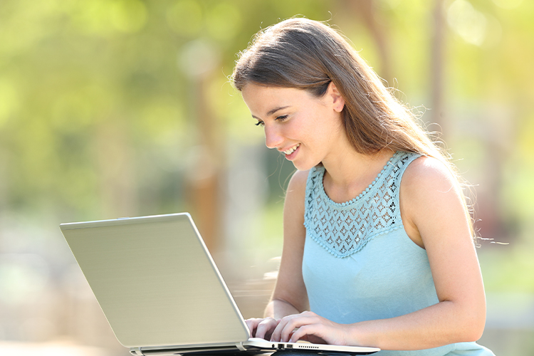 Student using a laptop outdoors
