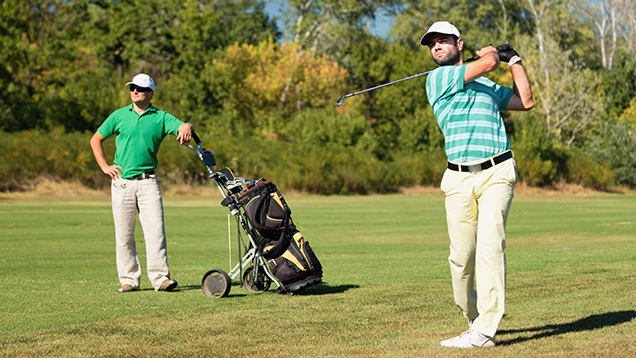 Two men playing golf