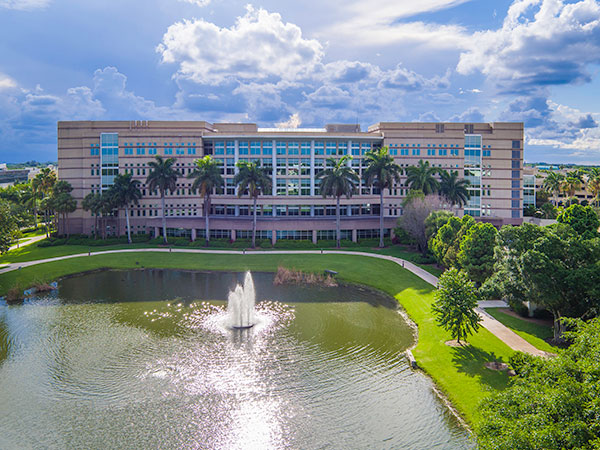 fountain in lake behind library