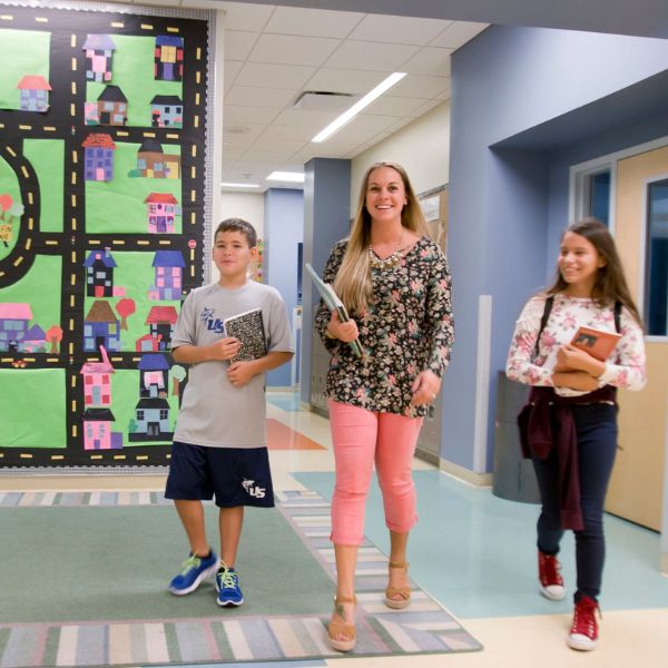 education student walking with two children