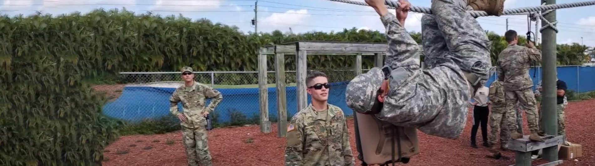 female rotc student climbing rope