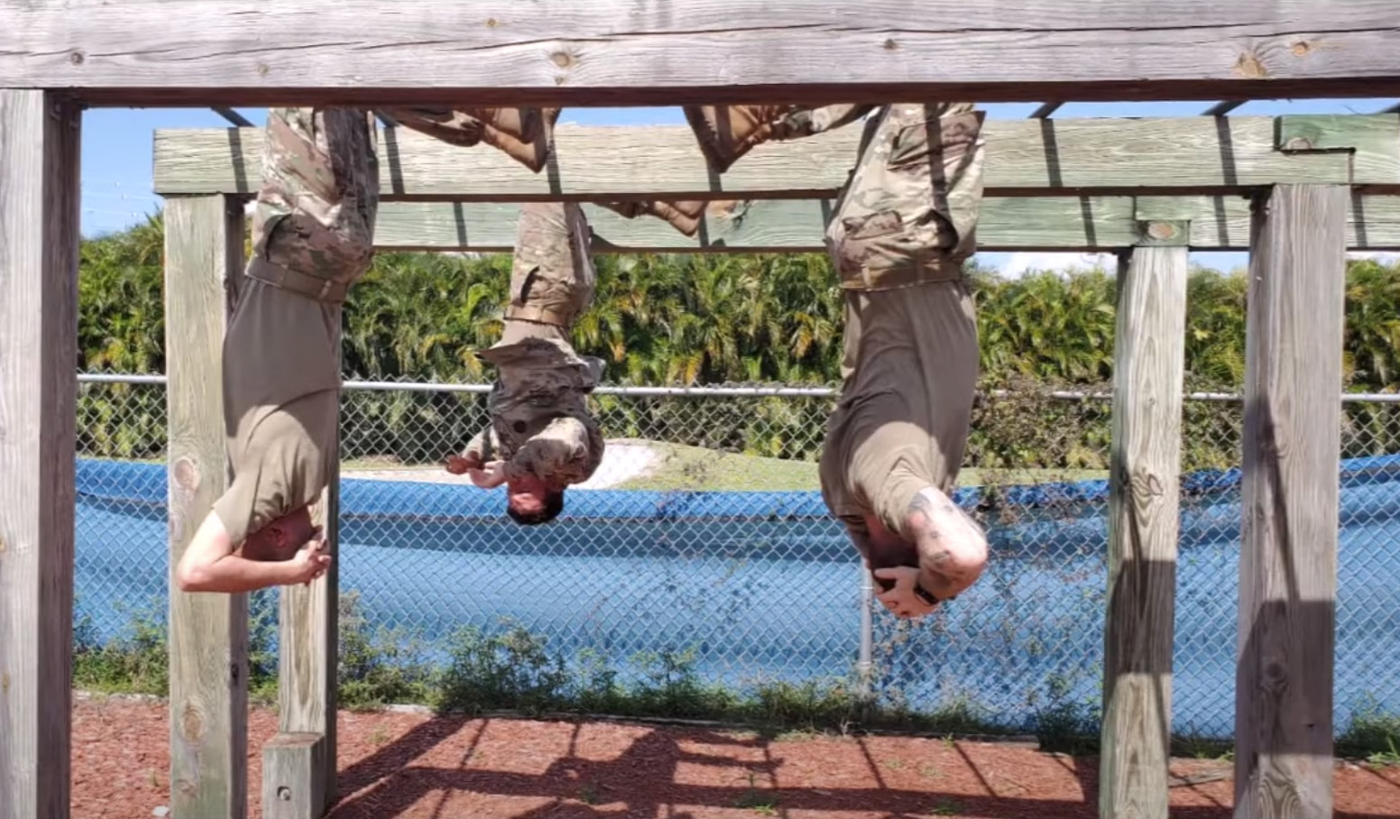 rotc students hanging from exercise bars