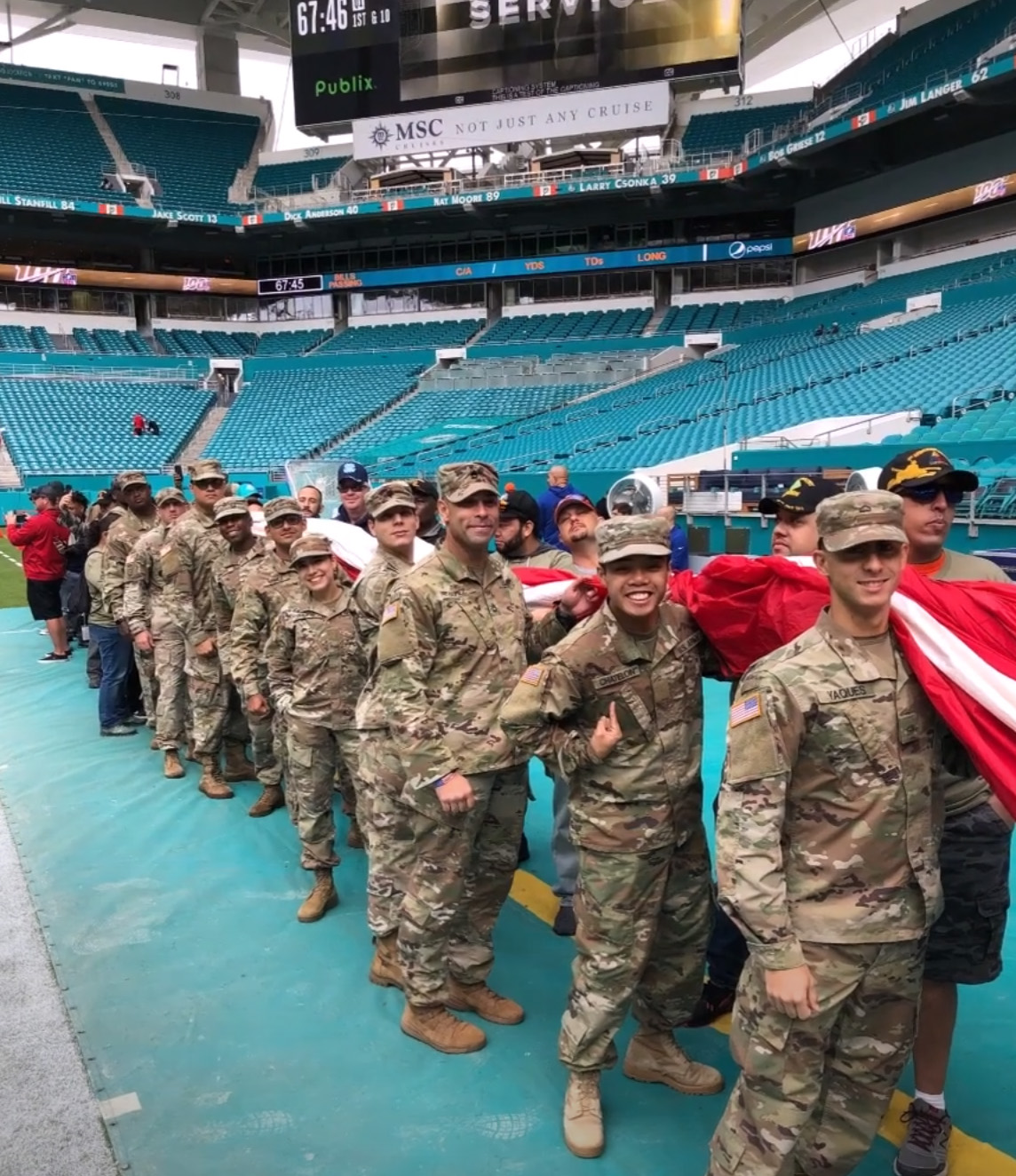 rotc carrying large flag at event