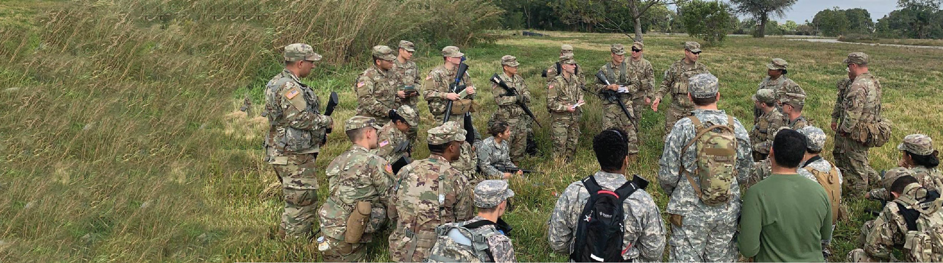 rotc students in a circle listening to leader