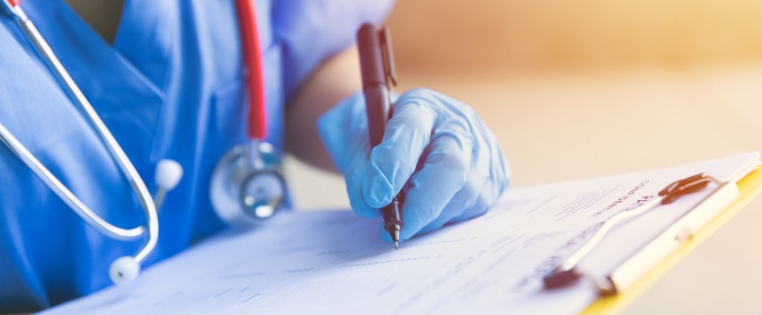 Nurses hand holding pen