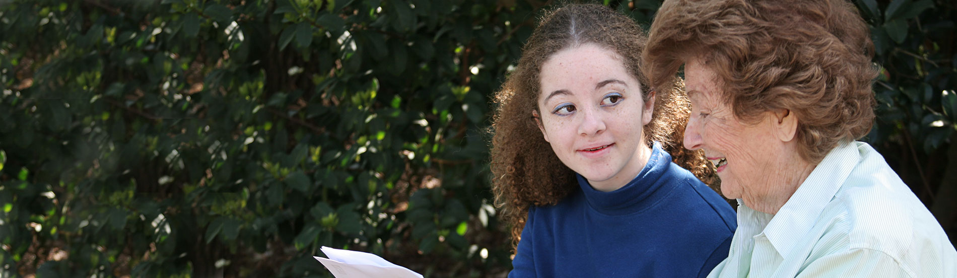 teen speaking with elderly woman