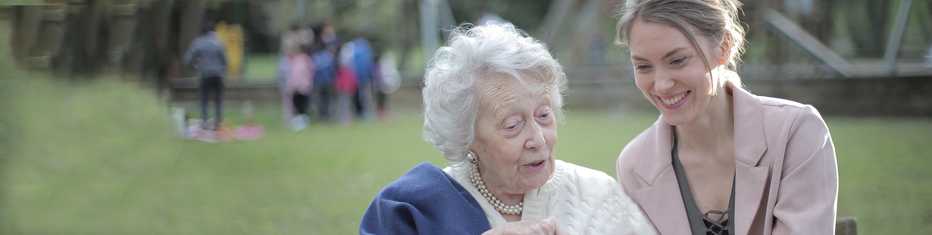 elderly woman speaking with young lady