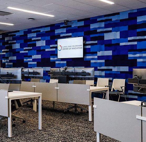 an image of a cybersecurity range with several desks and computers 