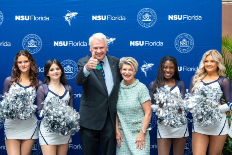 President Moon and Mrs. Moon posing with NSU Sharkettes
