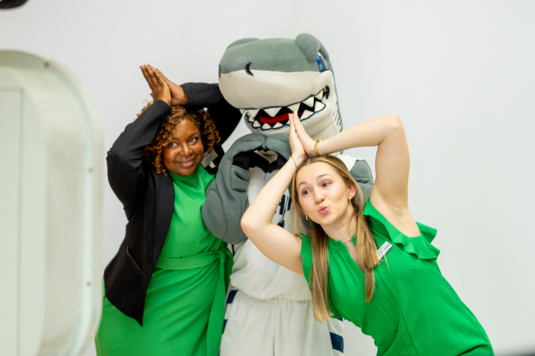 Staff posing with the NSU mascot