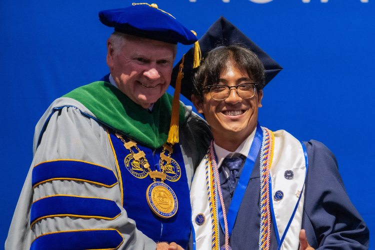 graduate-posing-with-dr-moon