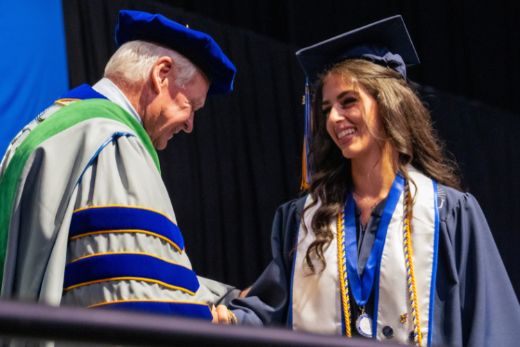 graduate-shaking-hands-with-dr-moon-on-stage