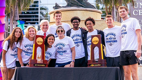 NSU basketball and swimming team members with President Hanbury and their championship trophies