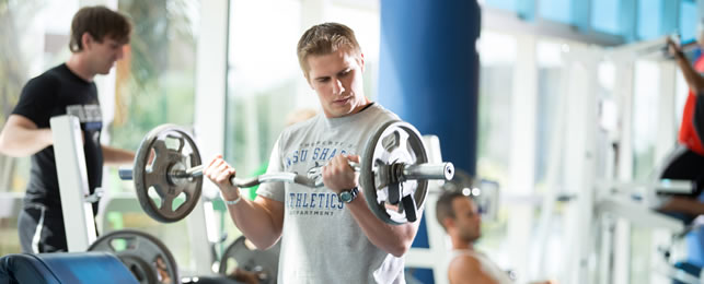 Student lifting weights in the Don Taft University Center RecPlex