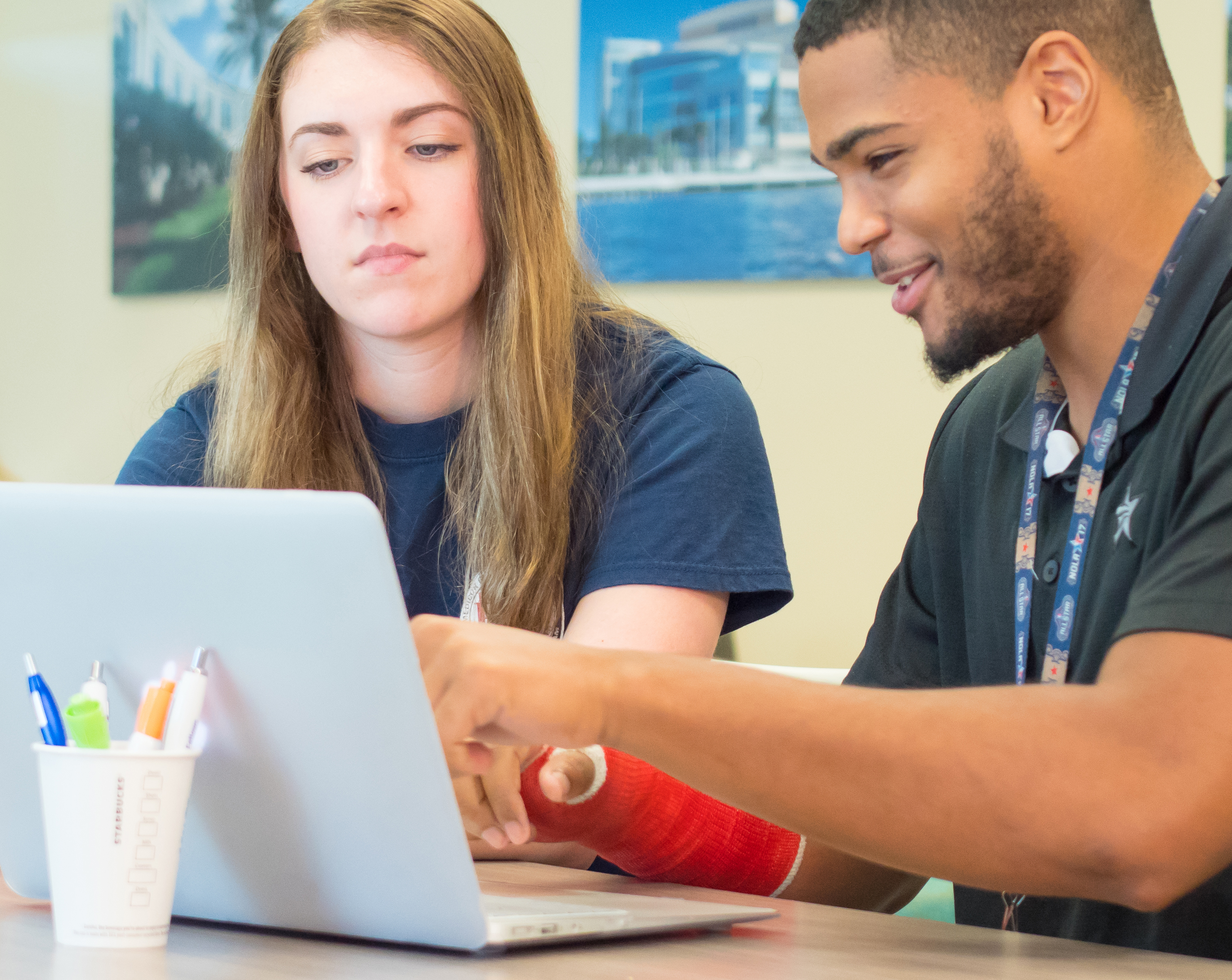 Students working on a laptop.